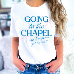 Camiseta Going to the Chapel Bride<br><div class="desc">The Going to the Chapel Bachelorette Collection blends playful charm with classic bridal style. Featuring a soft pink background paired with bold blue typography, this suite captures the excitement of a bride-to-be heading down the aisle. Delicate bow illustrations and a mix of elegant serif and flowing script fonts add a...</div>