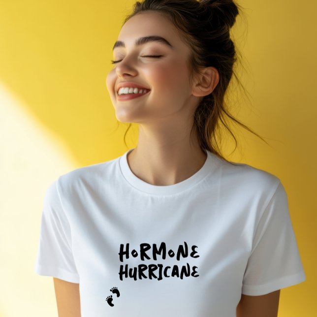 Camiseta Humorística impressão digital do bebê de gravidez  (Accompanying this striking visual is the lighthearted and amusing phrase "Hormone Hurricane,")