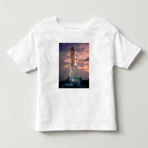 Camiseta Infantil Rupturas do alvorecer atrás de ASTP Saturn IB CDD