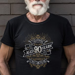 Camiseta Mens Funny Whiskey 90 Birthday<br><div class="desc">Celebre o grande 9-0 com estilo e humor com este design de aniversário inspirado no rótulo de uísque vintage. A tipografia negra, dourada e branca é ornamentado e elegante, dando-lhe um toque clássico de retrô-safra. Perfeito para o homem (ou para a mulher!) na sua vida que ama o seu uísque,...</div>