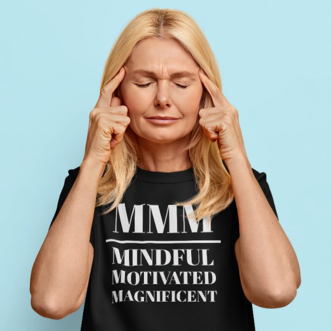 Camiseta MMM- Mindful, Motivated, Magnífico (Middle aged Caucasian woman wears a t-shirt that reads "MMM: Mindful, Motivated, Magnificent")