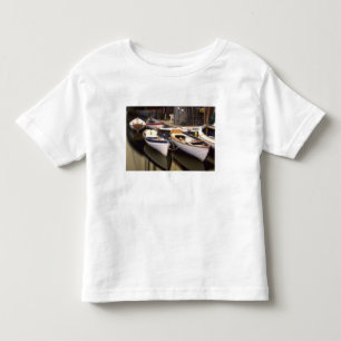 Camiseta Névoa cerca quatro barcos atracados.