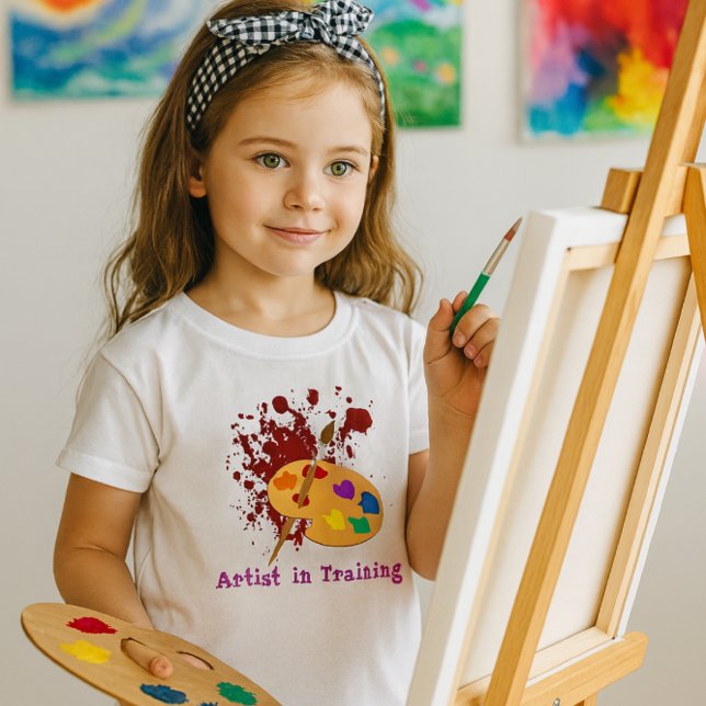 Camiseta Paint Splash Girls T Shirt (Artist in Training” youth tee with vibrant palette graphic perfect for creative young painters)