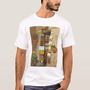 Camiseta Pequena loja com obras de arte à venda na calçada
