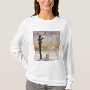 Camiseta Raízes, espingardas, dog tags e capacete de proteç