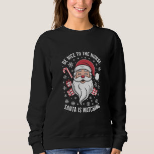 Camiseta Seja Bom para a Enfermeira o Papai Noel Está Obser