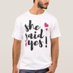 Camiseta She Said Yes! Engagement Celebration – Romantic<br><div class="desc">Celebrate one of life’s most unforgettable moments with this beautiful “She Said Yes!” text-based design. Perfect for engagement announcements, bridal celebrations, and wedding planning excitement, this romantic statement captures the joy of saying yes to forever. Ideal for T-shirts, mugs, invitations, stickers, and engagement party décor, this design makes a thoughtful...</div>
