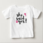 Camiseta She Said Yes! Engagement Celebration – Romantic<br><div class="desc">Celebrate one of life’s most unforgettable moments with this beautiful “She Said Yes!” text-based design. Perfect for engagement announcements, bridal celebrations, and wedding planning excitement, this romantic statement captures the joy of saying yes to forever. Ideal for T-shirts, mugs, invitations, stickers, and engagement party décor, this design makes a thoughtful...</div>