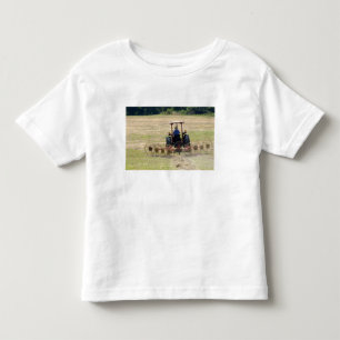 Camiseta Um menino dirigindo um trator colhendo