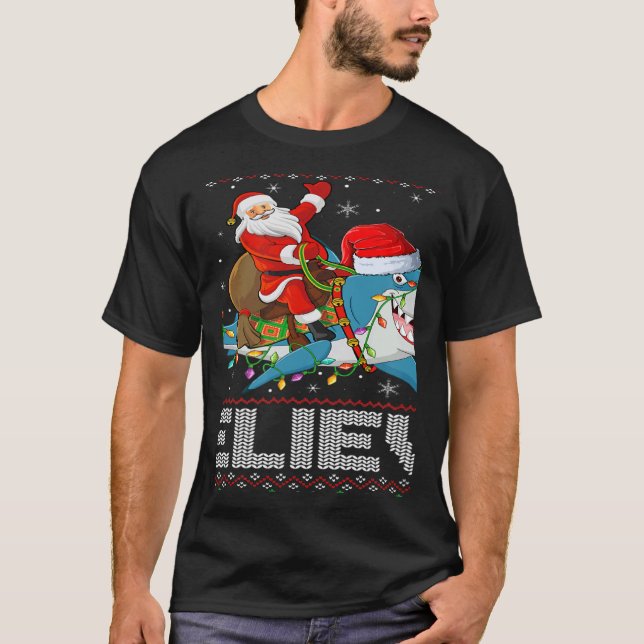 Camiseta Xmas Lights Shark Believe Ugly Santa Riding Shark  (Frente)