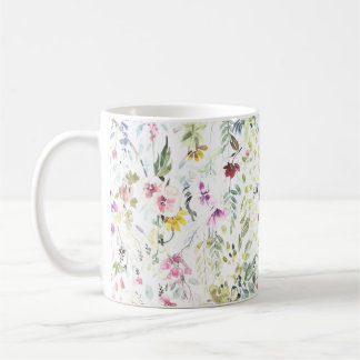 Caneca com a flor pintado mão e as plantas da