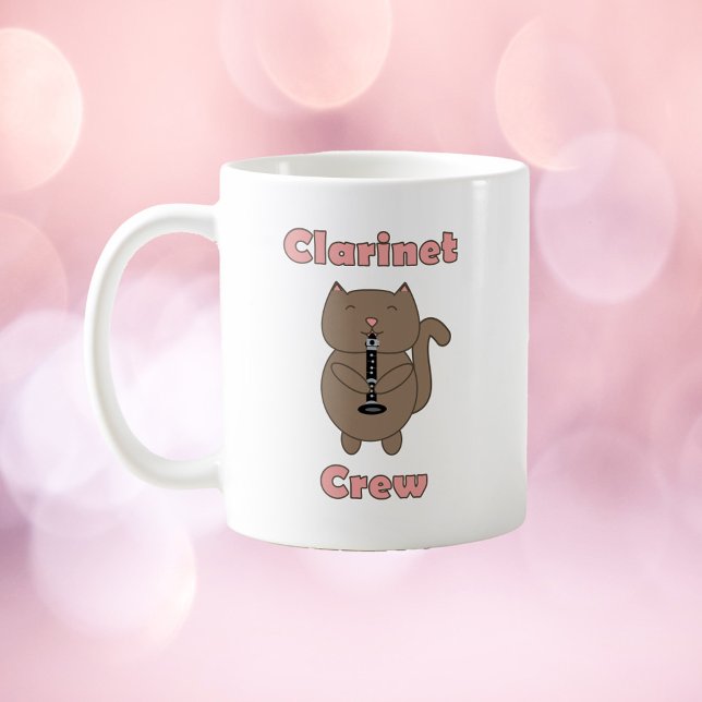 Caneca De Café Clarinet Crew (A mug with a brown cat playing the clarinet and the words clarinet crew in pink.)