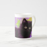 Caneca De Porcelana Gustav Klimt Black Kitten<br><div class="desc">Bone China Mug apresentando um gatinho preto Gustav Klimt! Esta beleza de olhos largos se coloca num campo verde de flores roxas. Um presente pensativo para amantes de gatos e entusiastas de arte austríacos!</div>