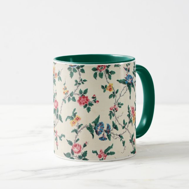 Caneca Padrão de flor multicolorida com acabamento verde, (Frente Esquerda)