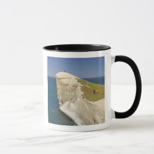 Caneca Turistas no topo do penhasco na Tunnel Beach