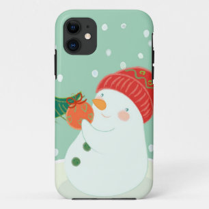 Capa Para iPhone 11 Um boneco de neve que pendura um ornamento em uma