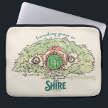 Capa Para Notebook Everything Grows in THE SHIRE™<br><div class="desc">Bring a little piece of Middle-Earth™ to your everyday with this charming Lord of the Rings™ design inspired by the cozy hills of Hobbiton. Featuring a storybook-style hobbit hole with its iconic round green door tucked into a lush hillside, the artwork is paired with the beloved phrase, “Everything grows in...</div>