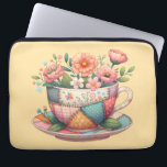 Capa Para Notebook Patchwork Teacup with Whimsical Flowers<br><div class="desc">A charming fusion of cozy cottagecore and nostalgic patchwork, this design features a teacup bursting with whimsical florals in soft, pastel hues. Each panel of the teacup is adorned with vintage-inspired fabric patterns—plaids, florals, and polka dots—stitched together with visible seams for a handmade, quilt-like look. The surrounding flowers bloom in...</div>