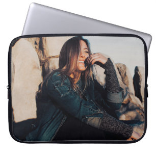 Capa Para Notebook Sentada e sorridente vestindo calças pretas
