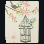 Capa Smart Para iPad Aves Pequenas Empoleiradas em uma ramificação e em<br><div class="desc">Nancy Slocum pintou muitas aves ao longo dos anos. Essa imagem retrata dois pequenos pássaros azuis e amarelos perdidos em um galho cercado por flores cor-de-rosa e que parecem curiosos sobre uma gaiola. Consiga esta legal peça de arte sobre pássaros no seu produto Zazzle hoje.</div>