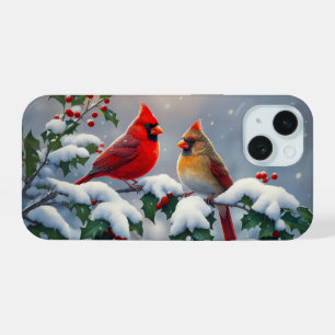 Cardeais vermelhos e Holly na neve