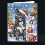 Cartão Akita Dog Winter Wonderland Natal Joy<br><div class="desc">seu design festivo captura o espírito alegre da época de férias, apresentando um adorável filhote vestindo um chapéu de Papai Noel. O gato está aninhado numa terra maravilhosa de inverno, completo com um boneco de neve, uma árvore de Natal decorada, e presentes lindamente envoltos. Os flocos de neve caem suavemente,...</div>