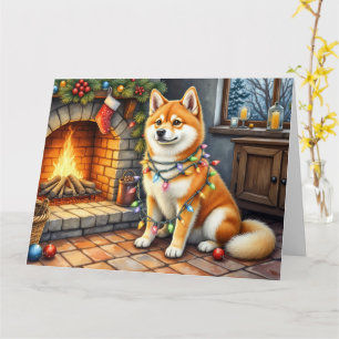 Cartão Akita Sentado ao Lado da Lareira com Luzes de Nata