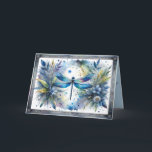 Cartão Blue Dragonfly Botanical Watercolor<br><div class="desc">A luminous blue dragonfly spreads delicate wings across a dreamy watercolor botanical scene, surrounded by soft florals, airy leaves, and scattered paint splashes. Shades of sapphire, teal, indigo, and gentle pastel greens blend into a light, painterly background that feels calm and enchanting. The dragonfly’s iridescent wings shimmer with layered watercolor...</div>