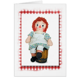 Cartão boneca de pano velha em barril de madeira