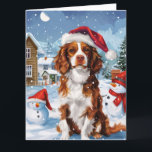 Cartão Brittany Spaniel Dog Winter Wonderland Natal<br><div class="desc">Este design festivo captura o espírito alegre da época de férias, apresentando um adorável filhote vestindo um chapéu de Papai Noel. O cachorro está aninhado numa terra maravilhosa de inverno, completo com um boneco de neve, uma árvore de Natal decorada, e presentes lindamente envoltos. Os flocos de neve caem suavemente,...</div>