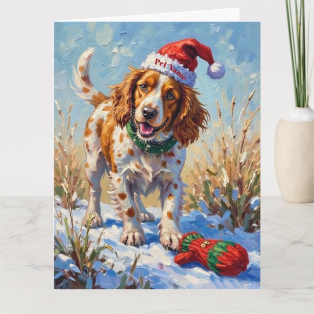 Cartão Brittany Spaniel Pointing at Santa's Glove Hat (Frente)