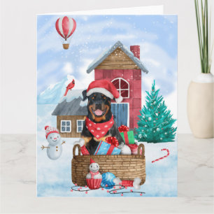 Cartão Cachorro Rottweiler na Casa de Natal na Neve
