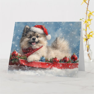 Cartão Cão Keeshond em Trenó Deixe Nevar Natal