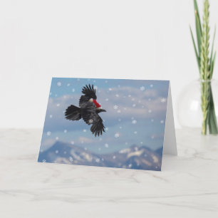 Cartão corvo de Natal voando sobre montanhas nevadas