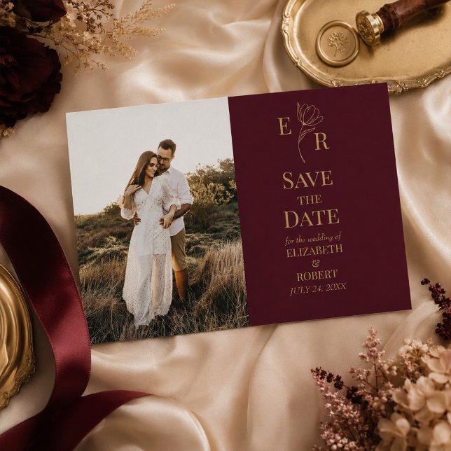 Cartão de Data de Salvamento de Foto Monograma Flo (Burgundy Floral Monogram Photo Save the Date Card on an a wedding table with elegant decor & flowers)