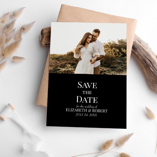 Cartão de Data de Salvamento de Foto Personalizada (Modern Black Custom Photo Save the Date Card on a table with neutral boho decoration.)