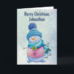 Cartão De Festividades Bonito bonitão segurando sinos de Natal, Snowy<br><div class="desc">Este cartão personalizável tem um bonitinho bonitinho bonitinho de boneca de neve em um lenço e boné. Está segurando sinos de Natal em fitas. Em um fundo de gradiente azul de neve. Dentro é uma imagem maior dos sinos. As cores são na sua maioria azuis e pinks. Você pode alterar...</div>