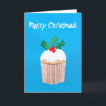 Cartão De Festividades Cupcake do Natal com azevinho<br><div class="desc">Um cartão de Natal brilhante e colorido com um sprig do azevinho sobre um cupcake congelado, de um design de papel pintado à mão da colagem por Judy Adamson. O cumprimento dianteiro, no texto branco em um fundo azul brilhante, é "Feliz Natal e o texto interno, que você pode personalizar,...</div>
