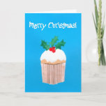 Cartão De Festividades Cupcake do Natal com azevinho<br><div class="desc">Um cartão de Natal brilhante e colorido com um sprig do azevinho sobre um cupcake congelado, de um design de papel pintado à mão da colagem por Judy Adamson. O cumprimento dianteiro, no texto branco em um fundo azul brilhante, é "Feliz Natal e o texto interno, que você pode personalizar,...</div>