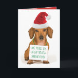 Cartão De Festividades Dachshund bonito com o Natal do Papai Noel<br><div class="desc">Dachshund bonito vestindo um chapéu de Papai Noel e um sinal ao redor do pescoço que diz: "Amor,  paz,  alegria". Muitas guloseimas e brinquedos picantes! O que mais um cachorro poderia pedir? Ou você pode mudar a cópia com sua própria mensagem inteligente.</div>