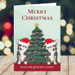 Cartão De Festividades Dois Caninos Tricolor Corgi - Fato Personalizado<br><div class="desc">Estes lindos cães tricolor Pembroke Welsh Corgi têm a cabeça inclinada dentro de um bonitinho chapéu de Papai Noel. Os dois filhotes estão sentados em frente a uma bonito árvore de Natal decorada com ornamentos coloridos. Um belo cartão de férias de corgis com um maravilhoso desenho de um duo de...</div>