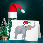Cartão De Festividades Elefante branco de Natal bonito em Santa Hat<br><div class="desc">Bons animais de férias são minha parte favorita do Natal. Um lindo elefante de cinza vestindo um chapéu vermelho de Papai Noel e parecendo feliz. Isto enche-me de espírito natalício. Personalize com o nome do destinatário do presente para personalizar o presente.</div>