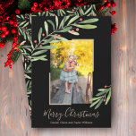Cartão De Festividades Elegante Watercolor Greenery Foto de Natal<br><div class="desc">Holly e bagas acenam sua foto favorita com seus nomes e saudando em letras quicas em qualquer cor na frente. ALTERE a cor de fundo (mostramos preto) e a cor do quadro também (mostramos ouro.)**ADICIONE mais fotos ou detalhes na parte traseira. Selecione Matte para o papel mais pesado e alta...</div>