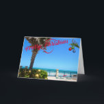 Cartão De Festividades Feliz Natal de Vero Beach Oceanfront<br><div class="desc">Feliz Natal de Vero Beach, Flórida! Esta colorida carta de saudação de temas tropicais apresenta uma foto de uma bela área oceânica de Vero Beach, toda decolada para as férias. A design festiva inclui as luzes de Natal na paisagem verde, as bolas de Natal penduradas num camarada de palma, e...</div>