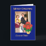 Cartão De Festividades Foto vermelha do Natal das poinsétias através das<br><div class="desc">Um cartão de Natal brilhante, festivo "através das milhas" a personalizar na capa com sua própria foto. O design inclui um pote do ouro-efeito de poinsétias vermelhas brilhantes em um fundo azul profundo de uma colagem de papel pintado à mão por Judy Adamson. Você igualmente pode mudar a mensagem interna...</div>