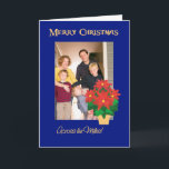 Cartão De Festividades Foto vermelha do Natal das poinsétias através das<br><div class="desc">Um cartão de Natal brilhante, festivo "através das milhas" a personalizar na capa com sua própria foto. O design inclui um pote do ouro-efeito de poinsétias vermelhas brilhantes em um fundo azul profundo de uma colagem de papel pintado à mão por Judy Adamson. Você igualmente pode mudar a mensagem interna...</div>