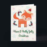 Cartão De Festividades Fox alaranjado no costume lunático do Natal do<br><div class="desc">Um encantamento personalizou o cartão de Natal com um dom retro. Uma ilustração de uma raposa alaranjada bonito, vestindo um chapéu vermelho do papai noel cercado por decorações do azevinho do Natal. Um animal pequeno doce da floresta. Ajuste em um fundo com os flocos de neve cor-de-rosa e azuis desvanecidos....</div>