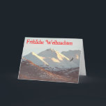 Cartão De Festividades Frohliche Weihnachten - Winter Eagle<br><div class="desc">Uma águia-careca voa perto da faixa de Chugach coberta pela neve perto de Anchorage,  AK. O texto alemão que lê "Frohliche Weihnachten" aparece a vermelho.</div>