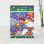 Cartão De Festividades Godson, Cute Reindeer e Snowman<br><div class="desc">Pelo Godson. Um cartão de Natal muito bonito e colorido. A ilustração mostra um doce veado com grandes olhos abertos e um boneco de neve divertido com um chapéu gigante que olha carinhosamente, nariz a nariz, um para o outro. Eles são colocados contra um céu azul de aquarela e a...</div>