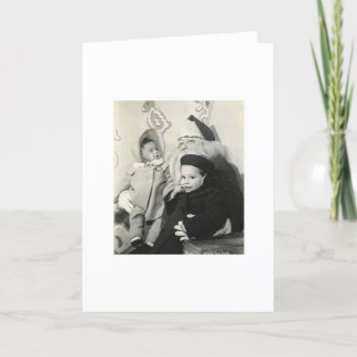 CARTÃO DE FESTIVIDADES MIÚDOS QUE SENTAM-SE NO REGAÇO DO PAPAI NOEL PARA